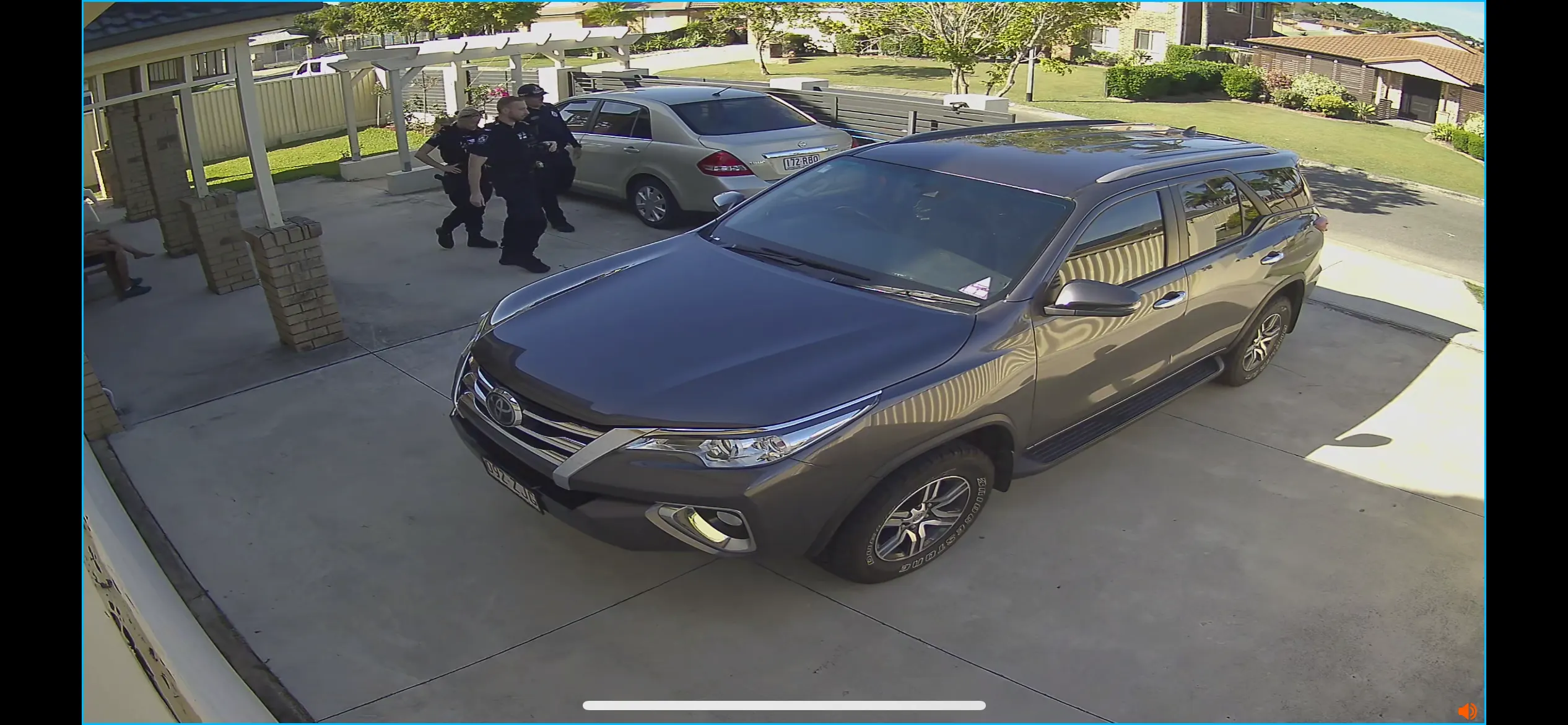 Front yard CCTV 15:25:42 — officers and residents on the property, 29 October 2025
